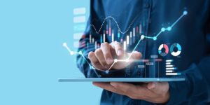 Person holding Tablet with Charts Holograms on top of the Screen